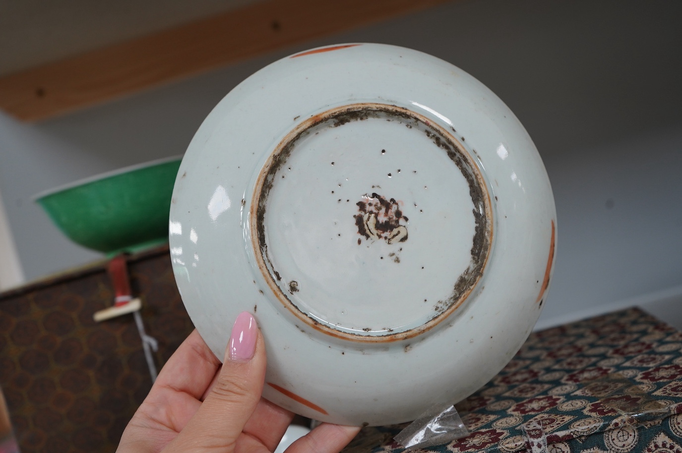 A set of four Chinese green glazed and moulded bowls and a famille rose dish, 19th and 20th century, boxed, largest 17cm. Condition - one bowl cracked